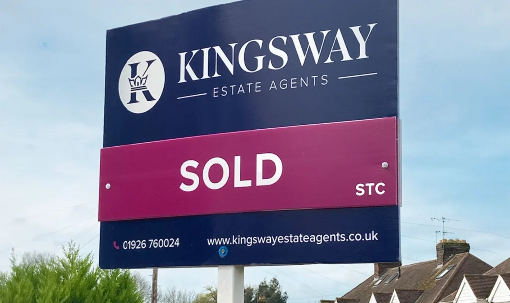Kingsway Estate Agents SOLD sign beside residential houses