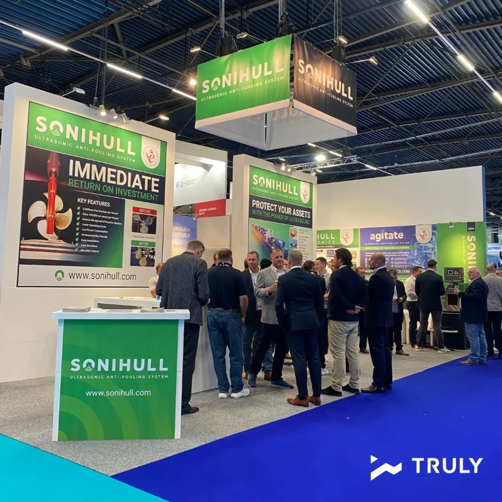Sonihull exhibition stand with promotional displays and visitors at a trade show
